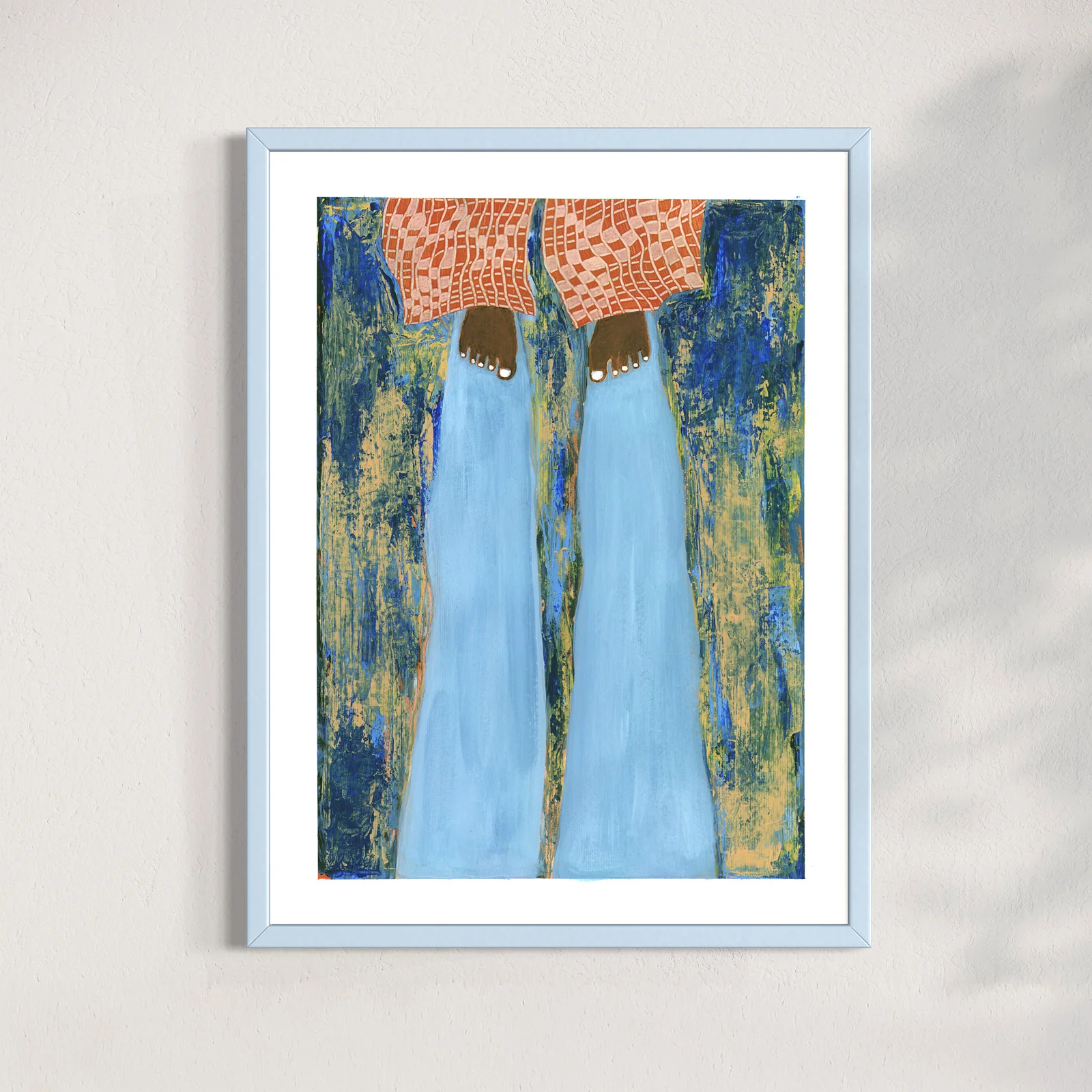 Framed abstract artwork collage, solskugga, by Jenny Atina, playful vibe with two brown feet and red pattern trousers against a textured, multicolored background and a light blue shadow. Warm tones on the wall evoke a calm, contemplative interior mood.